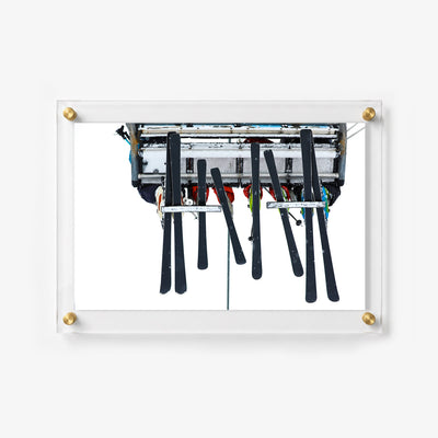 Winter acrylic wall art featuring a ski lift carrying riders and equipment 