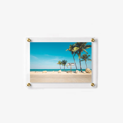 Summer beach wall art with a surf sign, golden sand, and clear tropical water