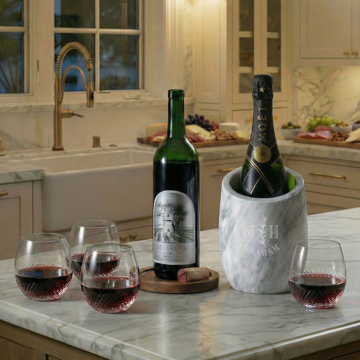 Four avignon glasses with wine bottles and a marble wine chiller