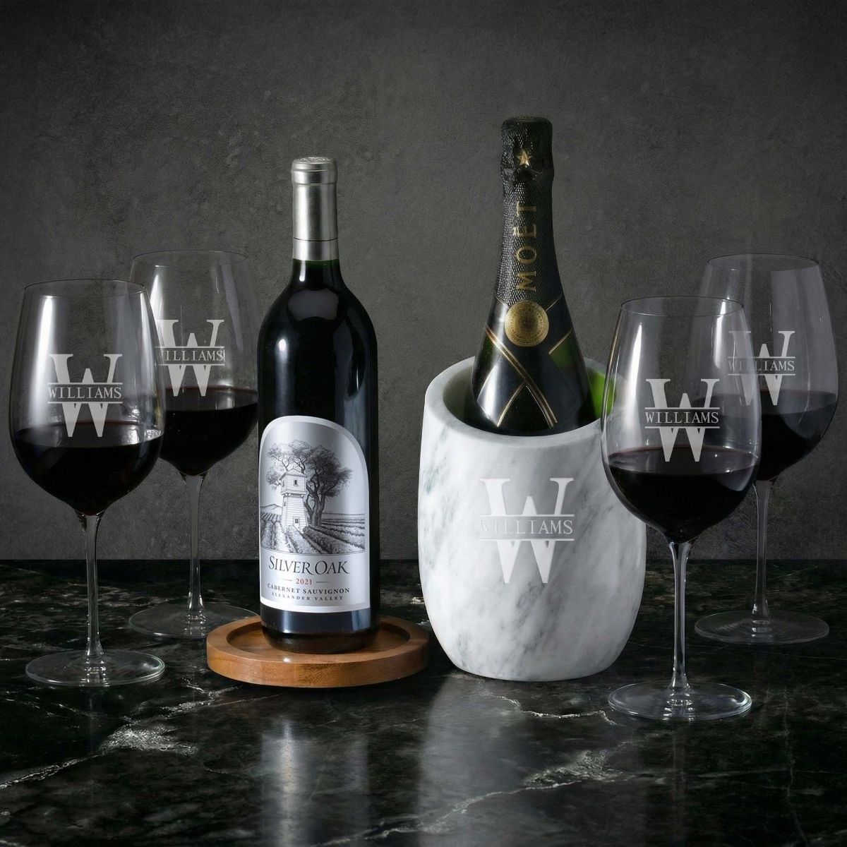 Wine bottles with marble wine chiller and four engraved wine glasses