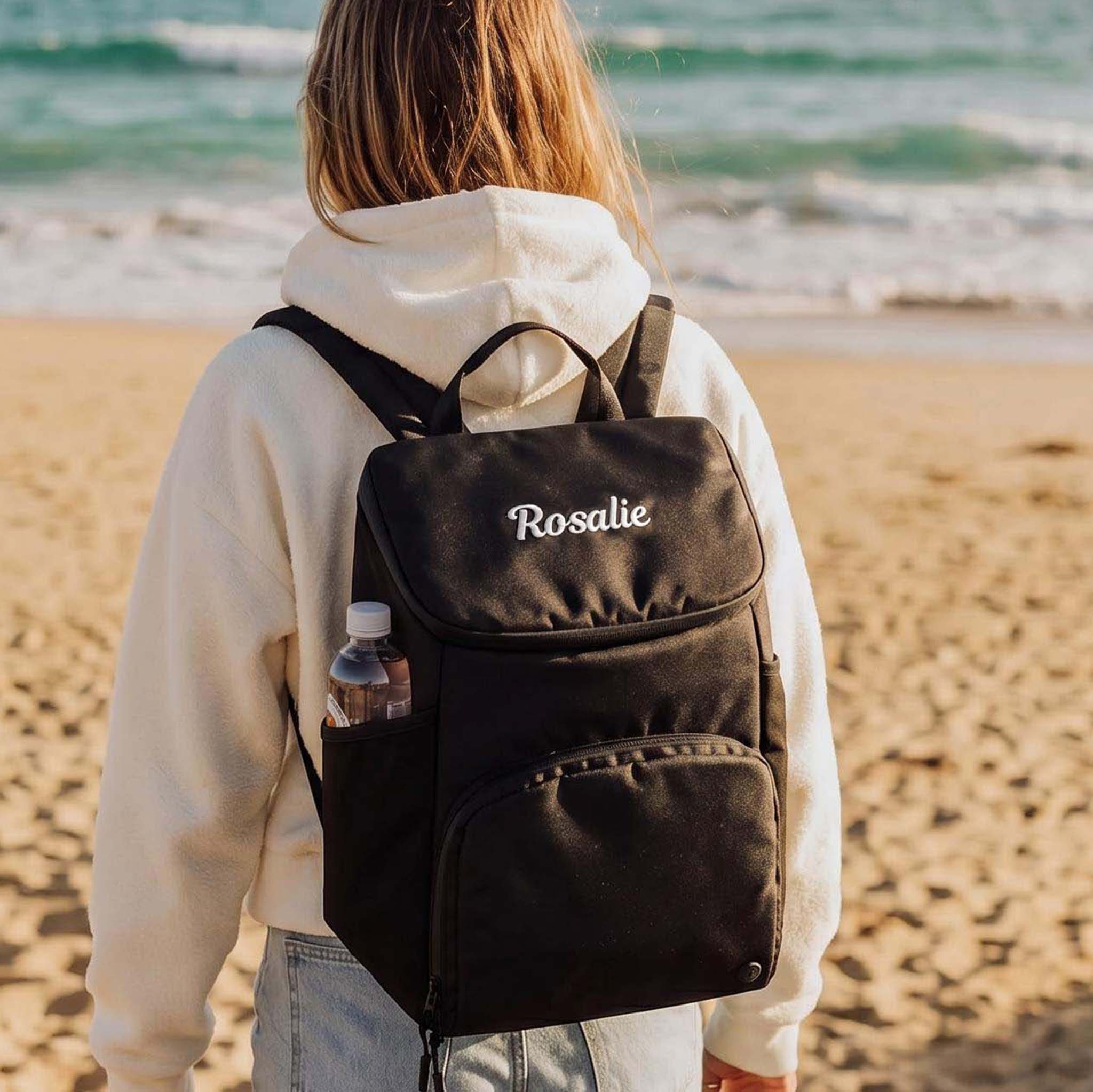 Woman wearing a backpack cooler bag on the beach 
