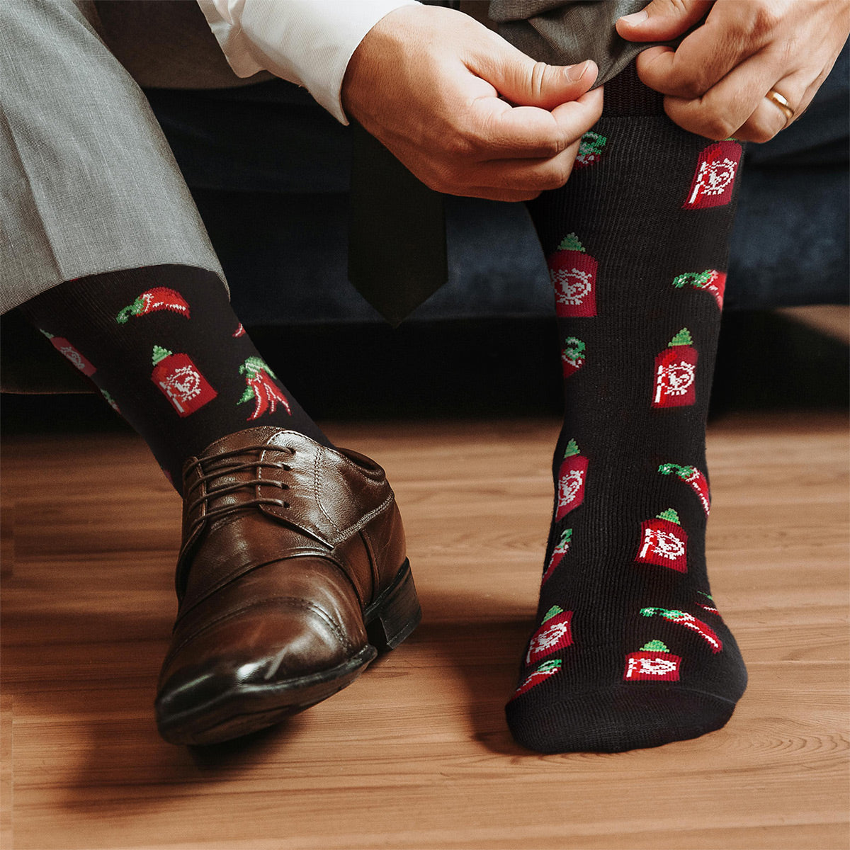 chili pepper graphic socks being worn by man and shown