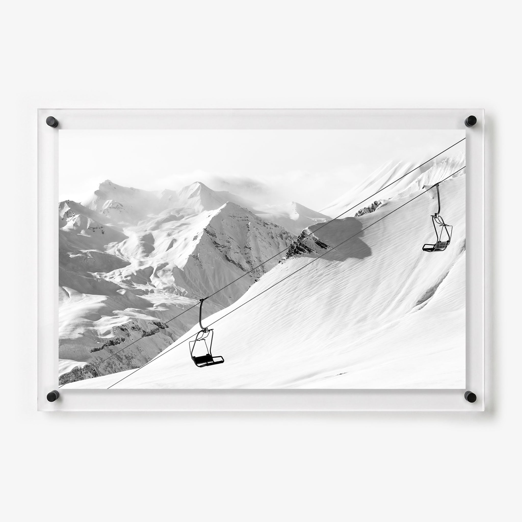 Black and white acrylic wall art featuring empty ski lifts