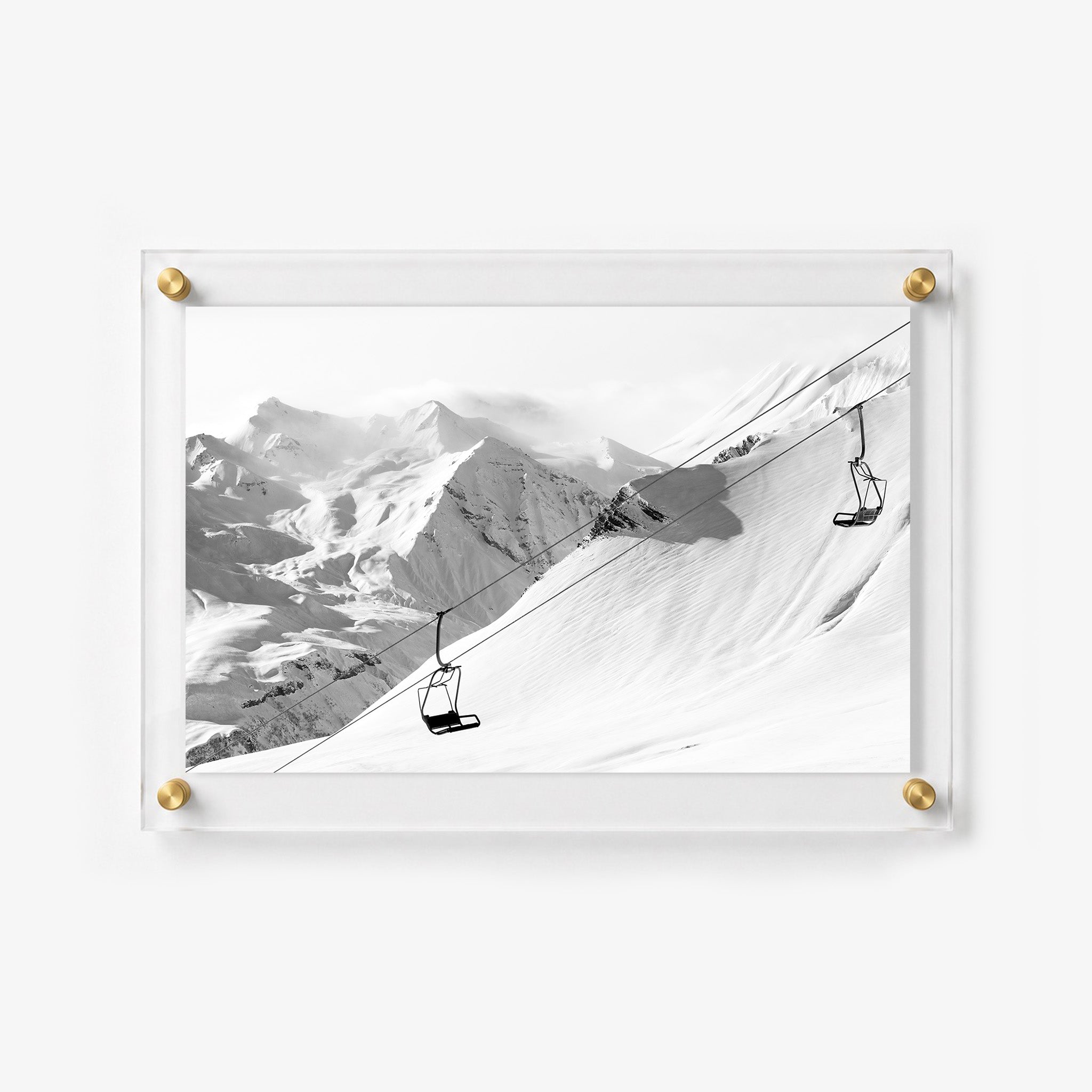 Snowy ski wall art with sweeping mountain views and empty lift chairs