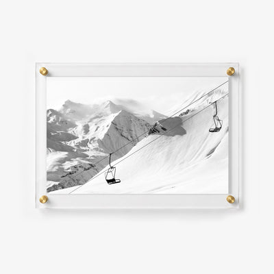 Snowy ski wall art with sweeping mountain views and empty lift chairs