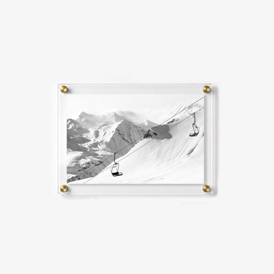 Mountain wall art showing vacant ski chairs above a peaceful snow covered slope