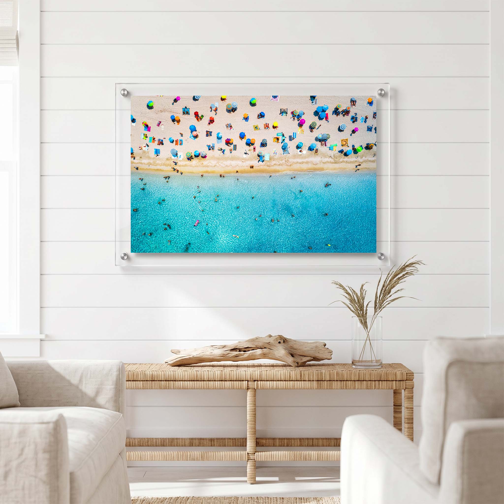 Acrylic wall art of a lively summer beach displayed in a living room