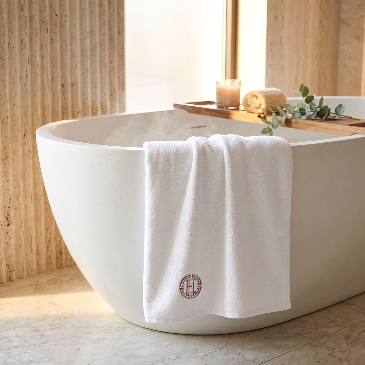 Personalized Rivera white Turkish cotton bath towel draped over a bathtub