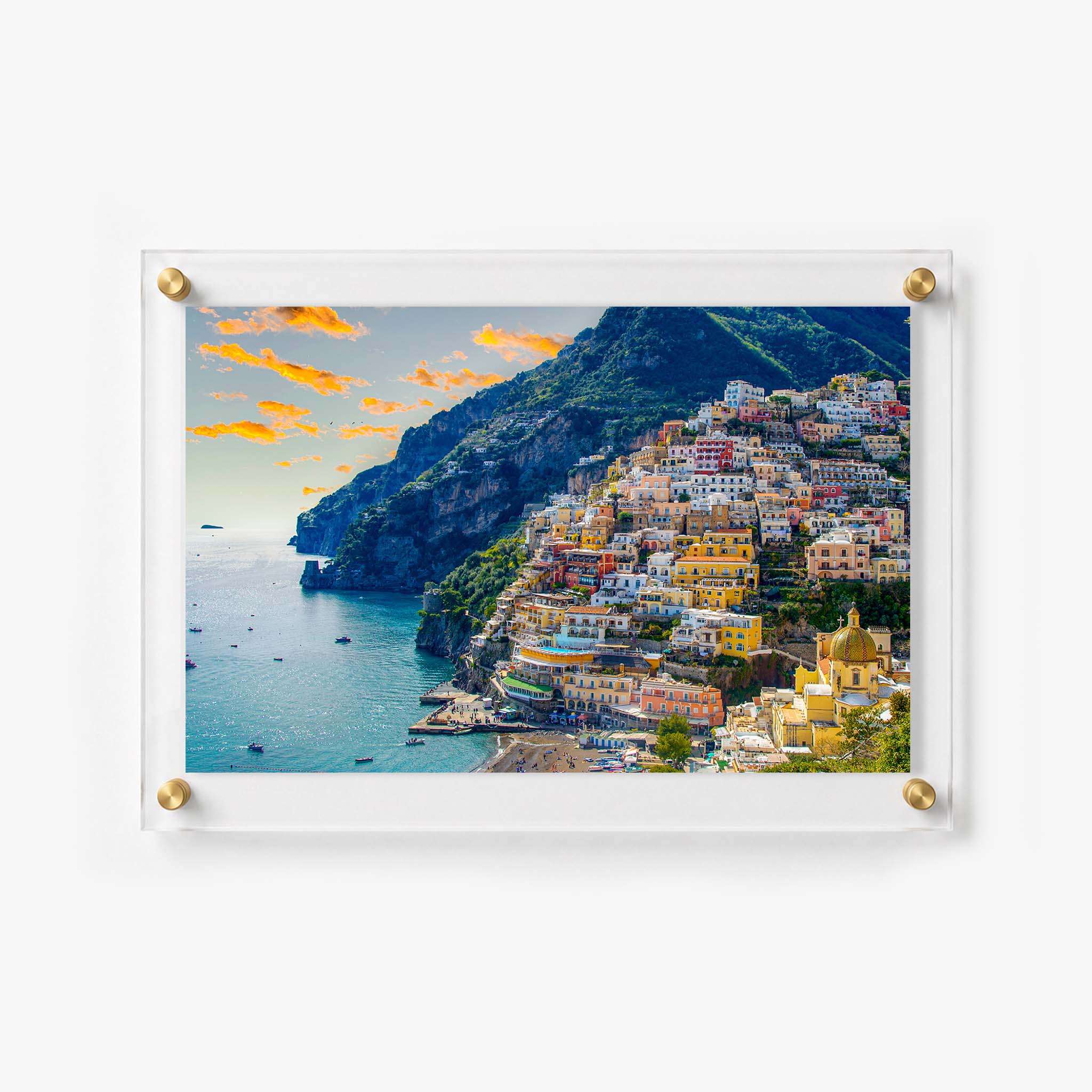 Scenic Italian coastal town with boats on the water and homes stacked along a steep hillside