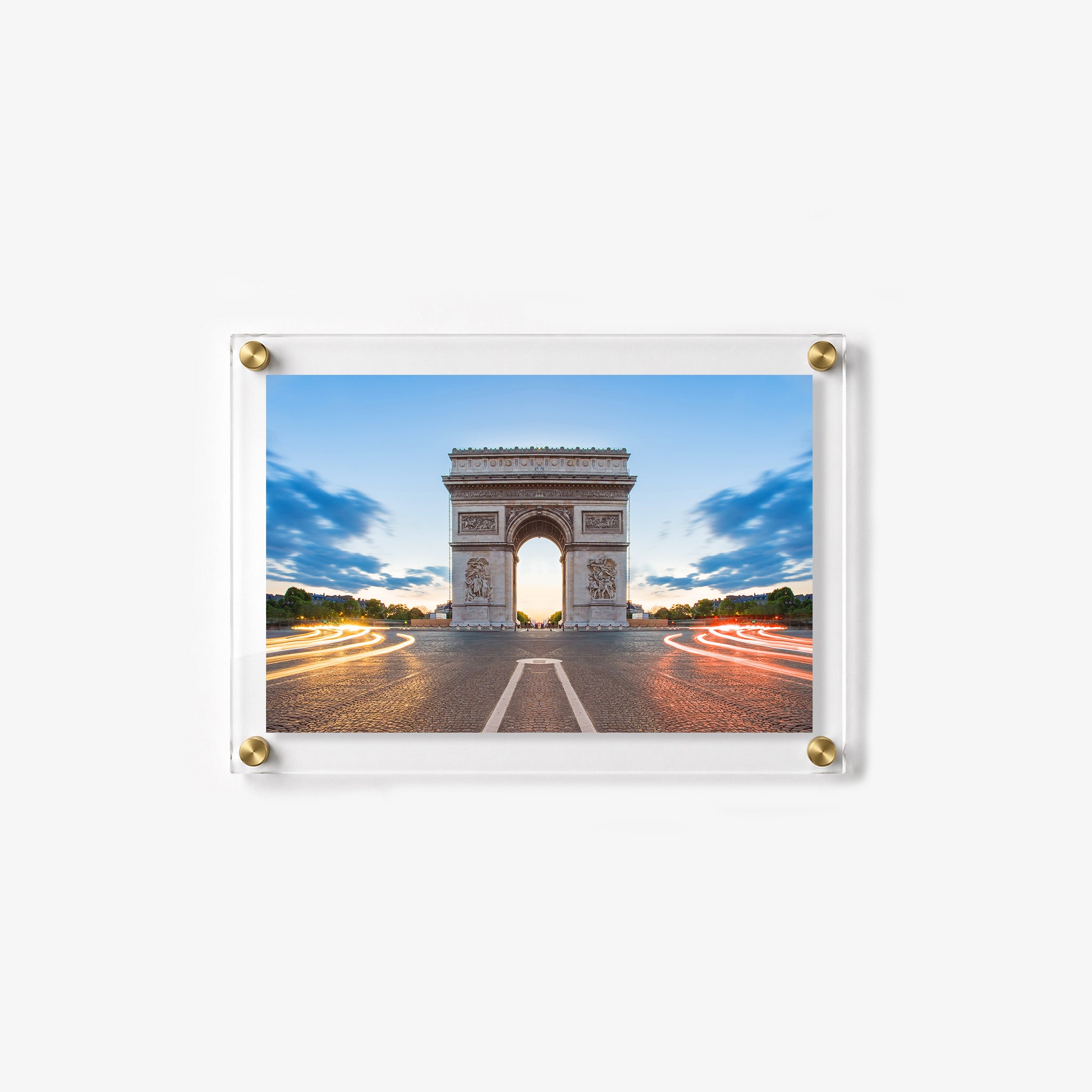 Long exposure city scene featuring the Arc de Triomphe and illuminated traffic at dusk