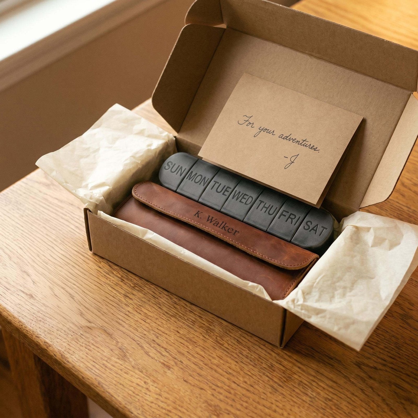 Personalized leather weekly pill case packaged in a gift box