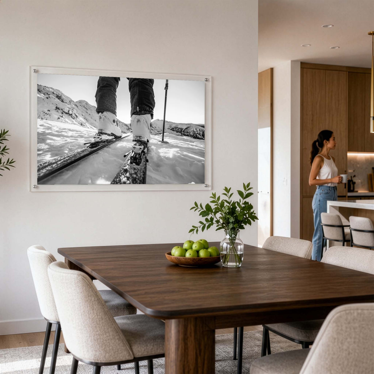 Black and white mountain road wall art in a modern dining room with a woman standing