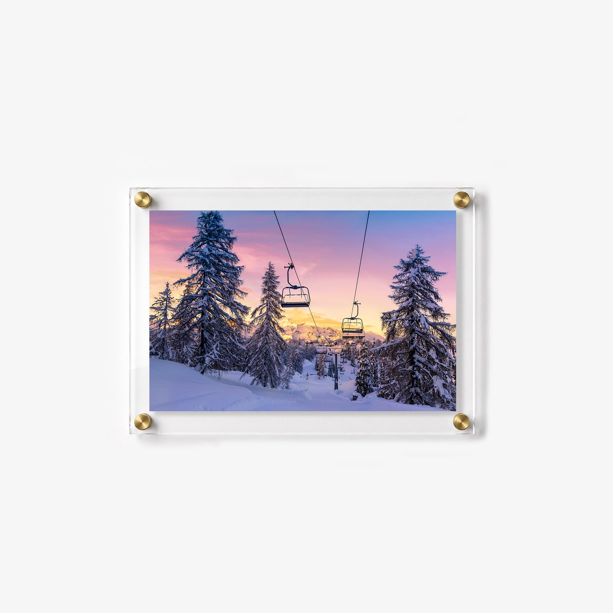 Mountain wall print showing a snowy ski slope framed by tall pine trees at sunset