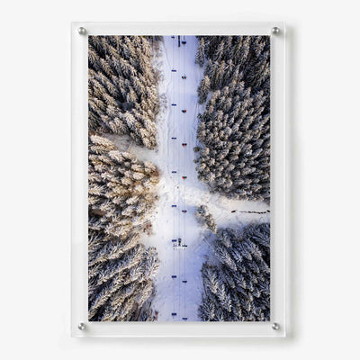 Acrylic wall art featuring an aerial view of a ski lift crossing a snow covered evergreen forest
