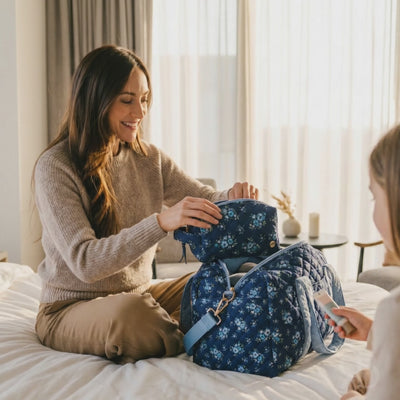 Quilted Duffle Carryall Weekender Bag in Daydream Navy with matching pouch used by a woman
