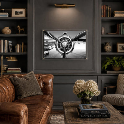 Prop Culture wall art decorating a dark moody library leather sofa