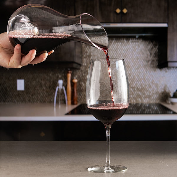 Slant Engraved Wine Decanter pouring red wine into a glass
