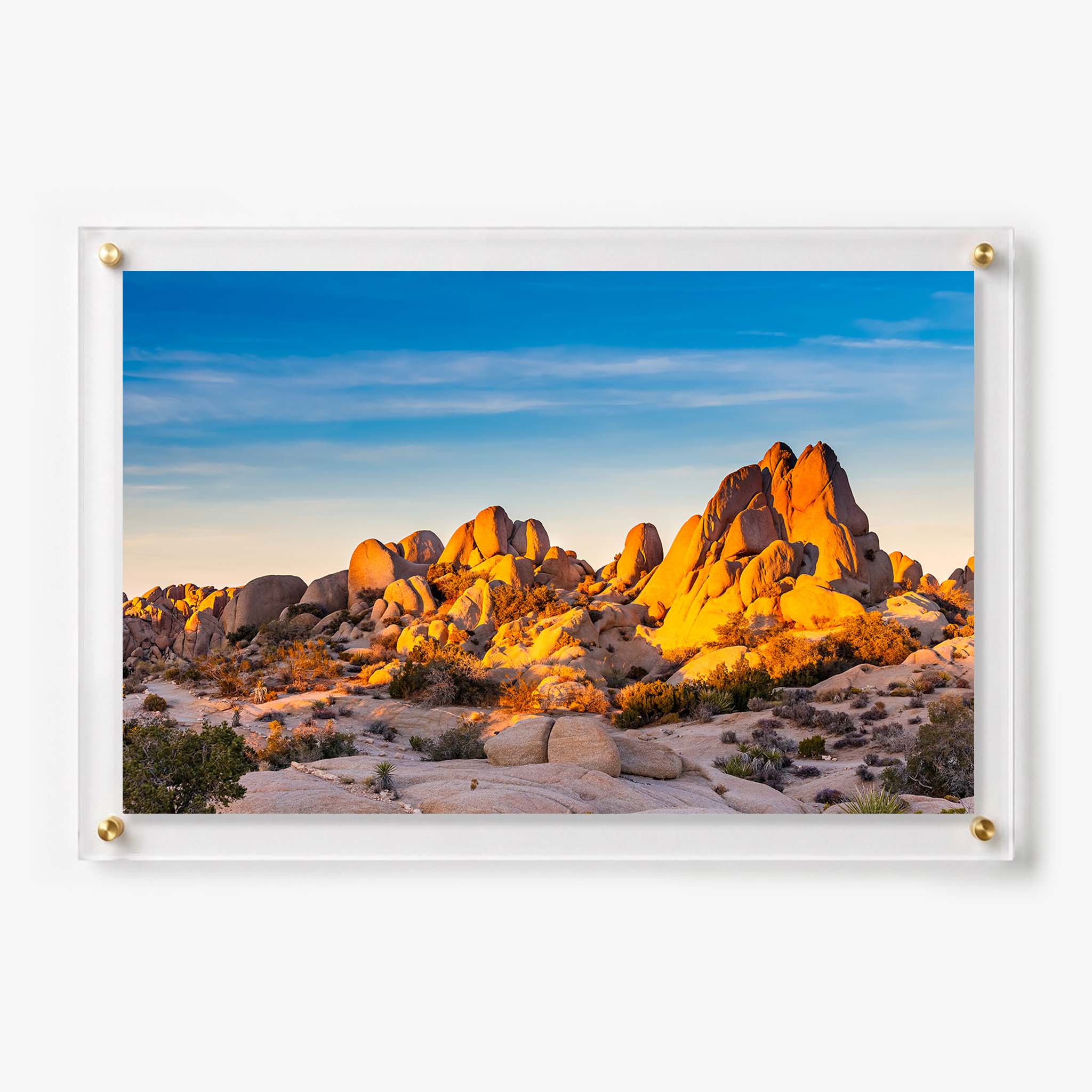 Acrylic wall art featuring sunlit desert boulders beneath a clear blue sky
