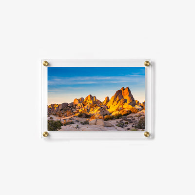 Sunlight highlights dramatic stone formations in this peaceful desert landscape