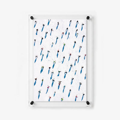 Colorful skiers scattered across a white ski trail in a vertical acrylic wall print