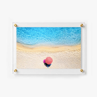 Coastal wall print featuring sparkling blue waves and a bright red beach umbrella