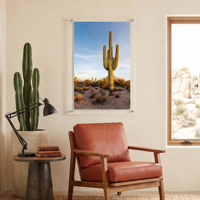 Vertical acrylic wall art of a towering cactus displayed in a seating corner