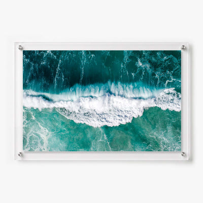 Acrylic wall art featuring an aerial view of turquoise ocean waves 