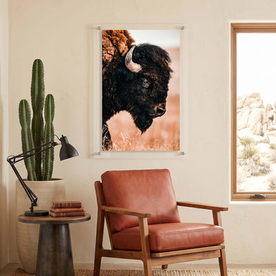 Rustic wall art featuring a detailed side profile of a buffalo displayed in a seating room