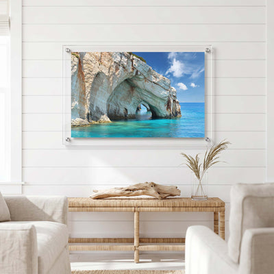 Natural sea arch carved into a pale limestone cliff displayed in a bright living room