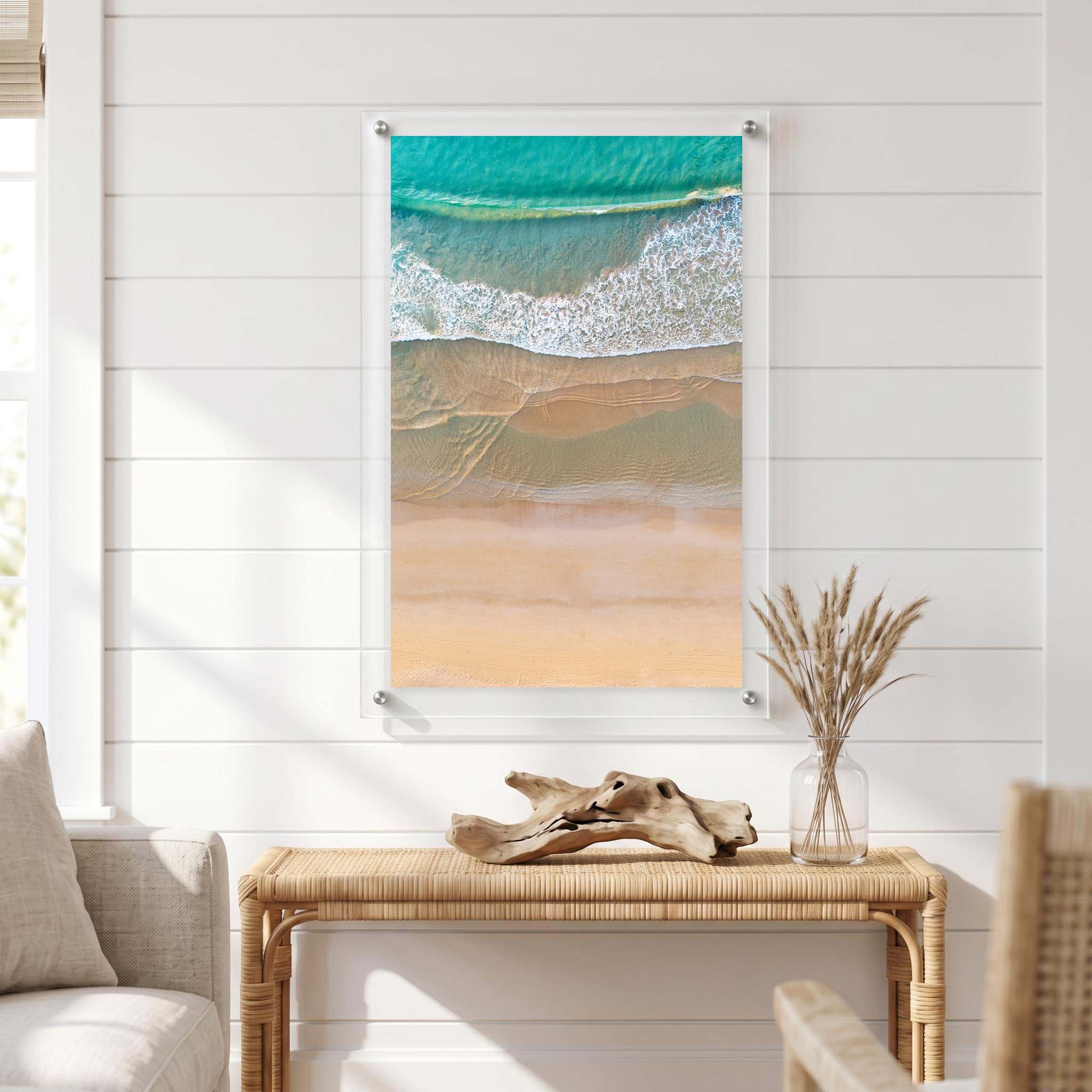 Ocean waves creating white foam patterns displayed in a bright room
