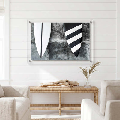 Black and white surf decor featuring two board tips displayed in a bright room