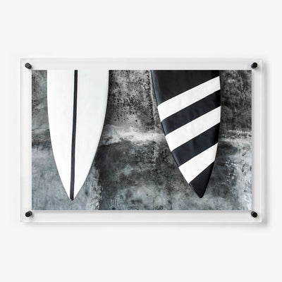 Acrylic wall art featuring two surfboard fins with black and white designs 