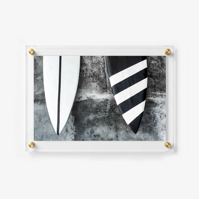 Horizontal acrylic print showing two surfboards with bold geometric designs