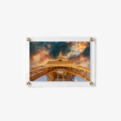 Clear acrylic print displaying an upward view of the Eiffel Tower in Paris at sunset
