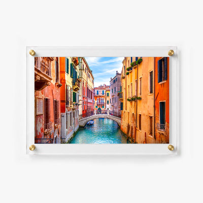 Venetian canal scene with turquoise water, historic buildings, balconies, and a small arched bridge
