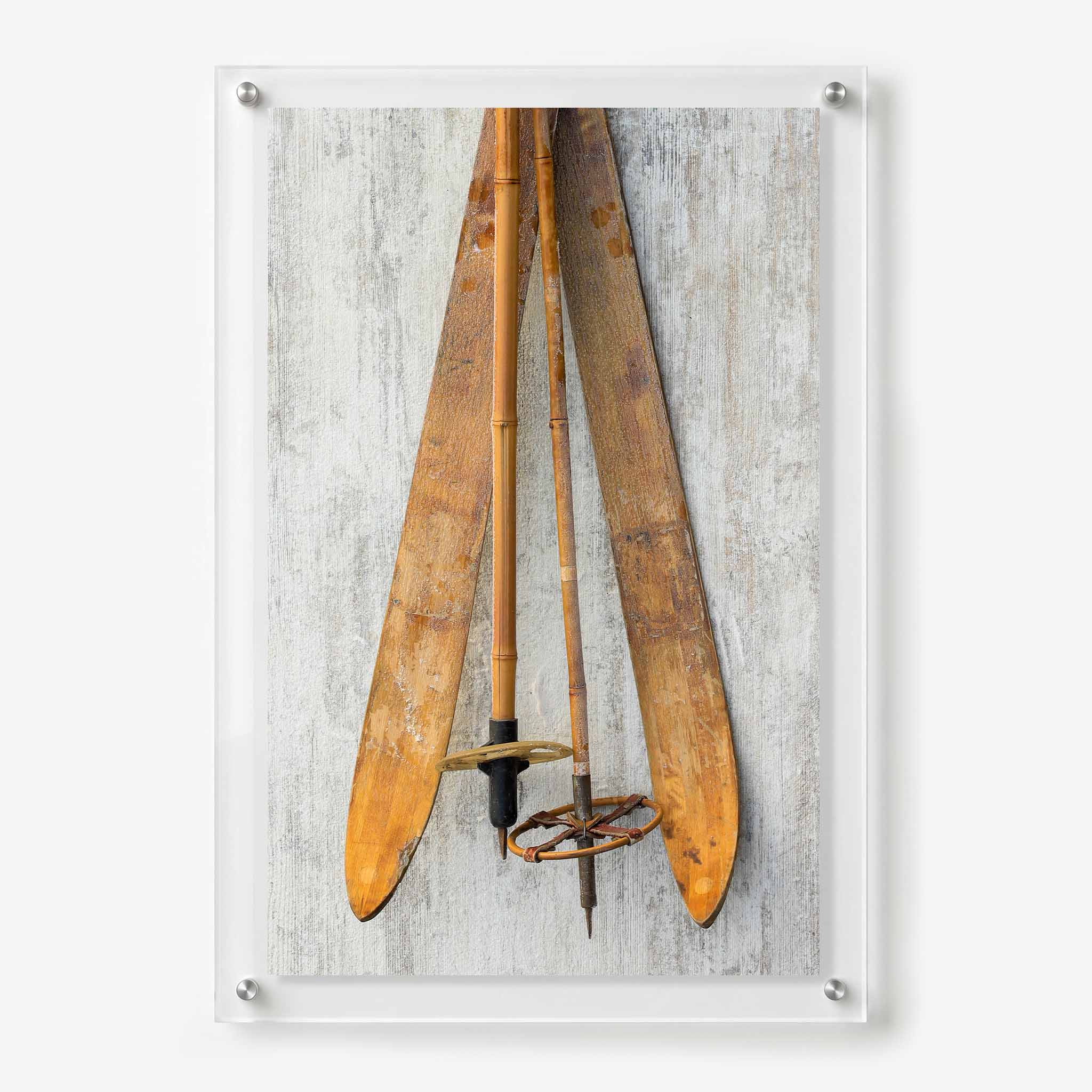 Acrylic wall art featuring vintage wooden skis and bamboo ski poles