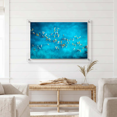 Coastal wall art featuring a large group of surfers displayed in a bright room