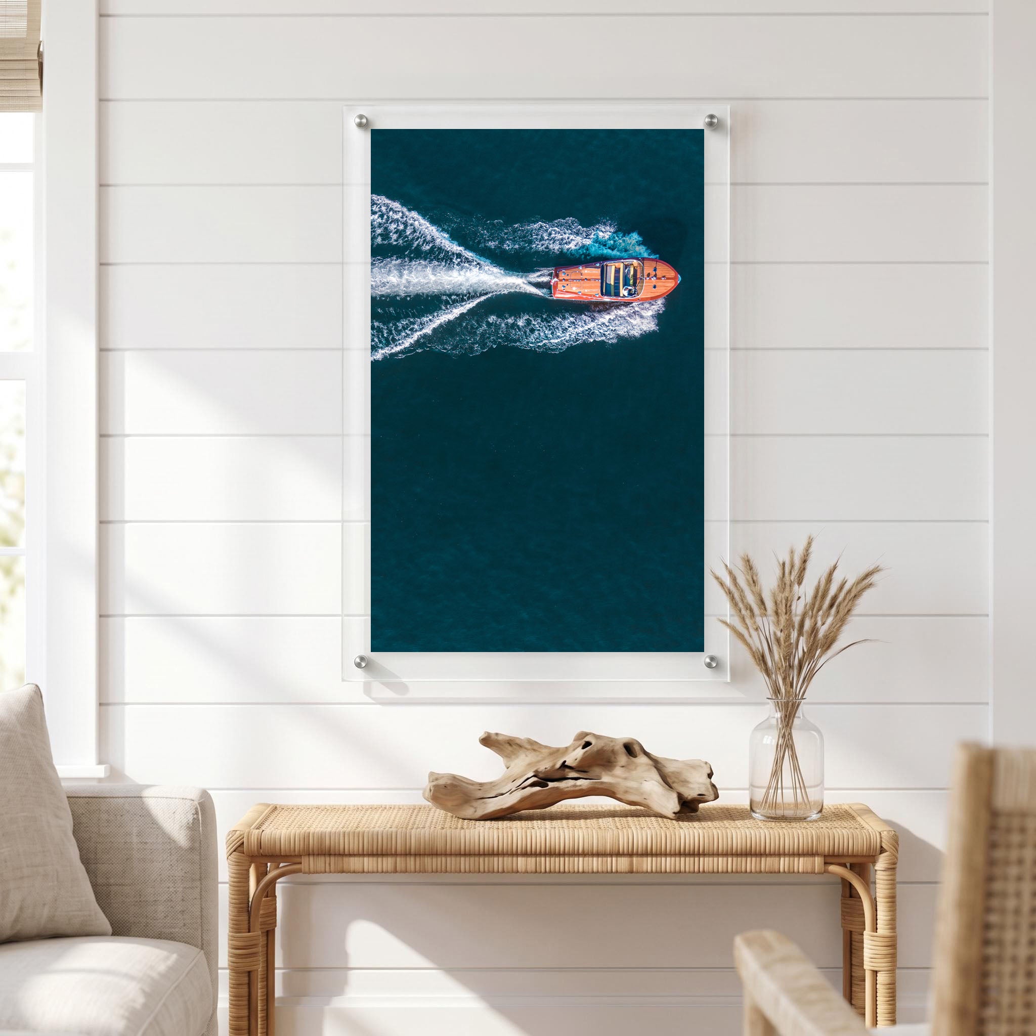 Vertical coastal wall art showing a speedboat displayed in a bright room