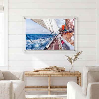 Nautical acrylic wall art showing a racing sailboat in motion displayed in a bright room