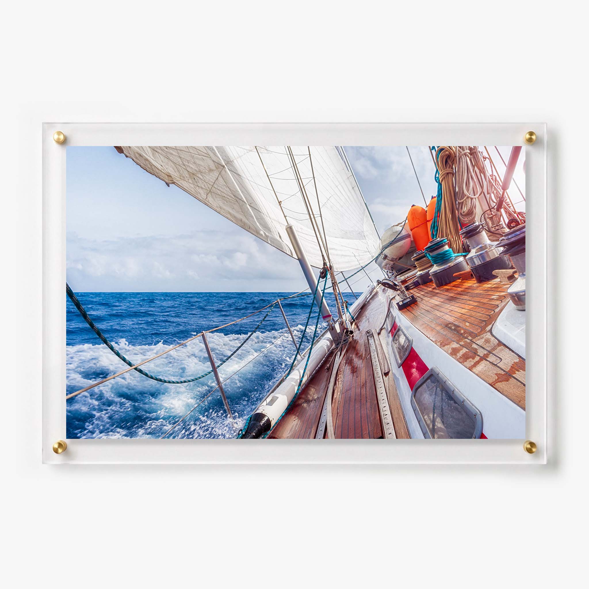 Acrylic wall art featuring a sailboat leaning through deep blue ocean waves