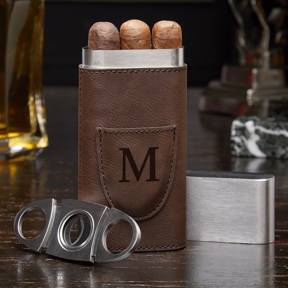 a cigar case & cutter made of stainless steel and wrapped with faux leather engraved with a single monogrammed initial of your chosen